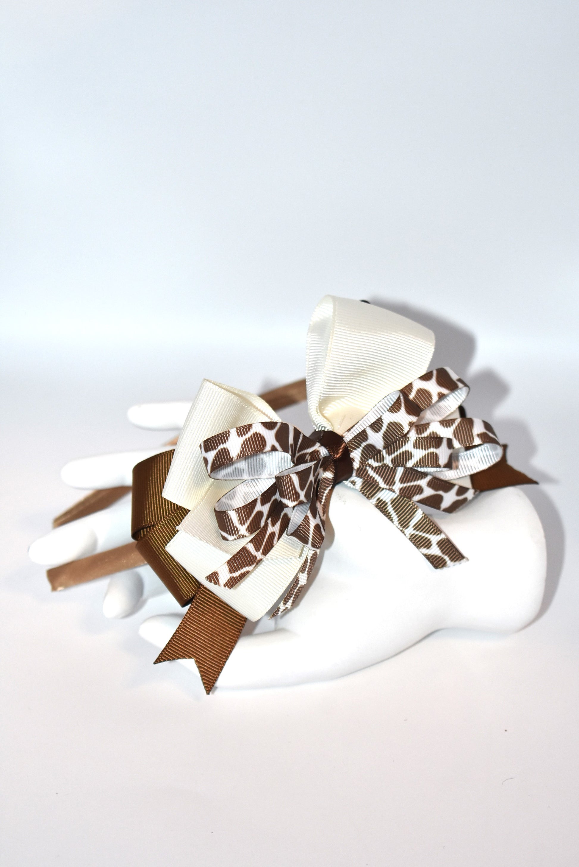 Bring a touch of whimsy to your look with this adorable cow print ribbon headband from Nana's Headband Collection. Featuring a charming brown and cream color combo on a thin satin cocoa brown band, it's as comfy as it is cute—perfect for all-day wear with a playful twist!