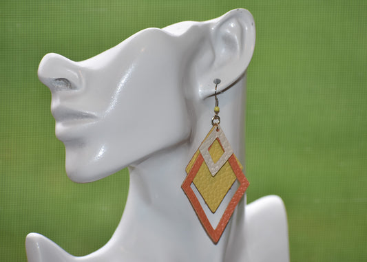 Our Orange Collection is 🤩 fun and stylish! These long hanging earrings come 🍊, 🍋 and cream-colored—a triangle of faux leather made for giving your outfit a 👍 oomph. But don't worry, the silver hypoallergenic hooks make 'em 🤗 comfy for everyday wear. Add a bit of flare to your look without weighing you down. 🤩