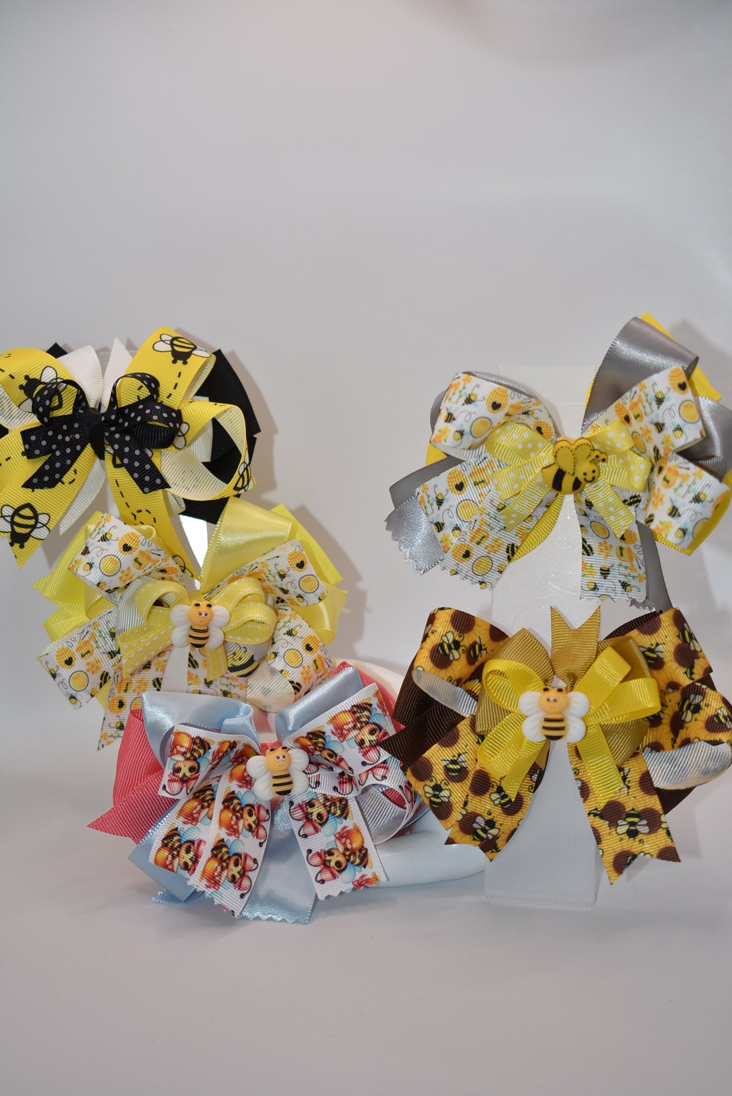 Get ready for summer with Nana's Collection 47! This adorable bumble bow is made of high-quality ribbon and features a cute bumble bee charm on top. Plus, the wrapped alligator clip ensures comfort all day long. Buzz on over and add this to your collection today!