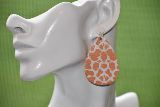 Be a real moo-d with these daring orange and white cow print faux leather earrings! Hangin' from white hypoallergenic posts, these cute and comfort-forward earrings will make you look super bovine with none of the discomfort - moo sure you'll forget you're even wearing them.