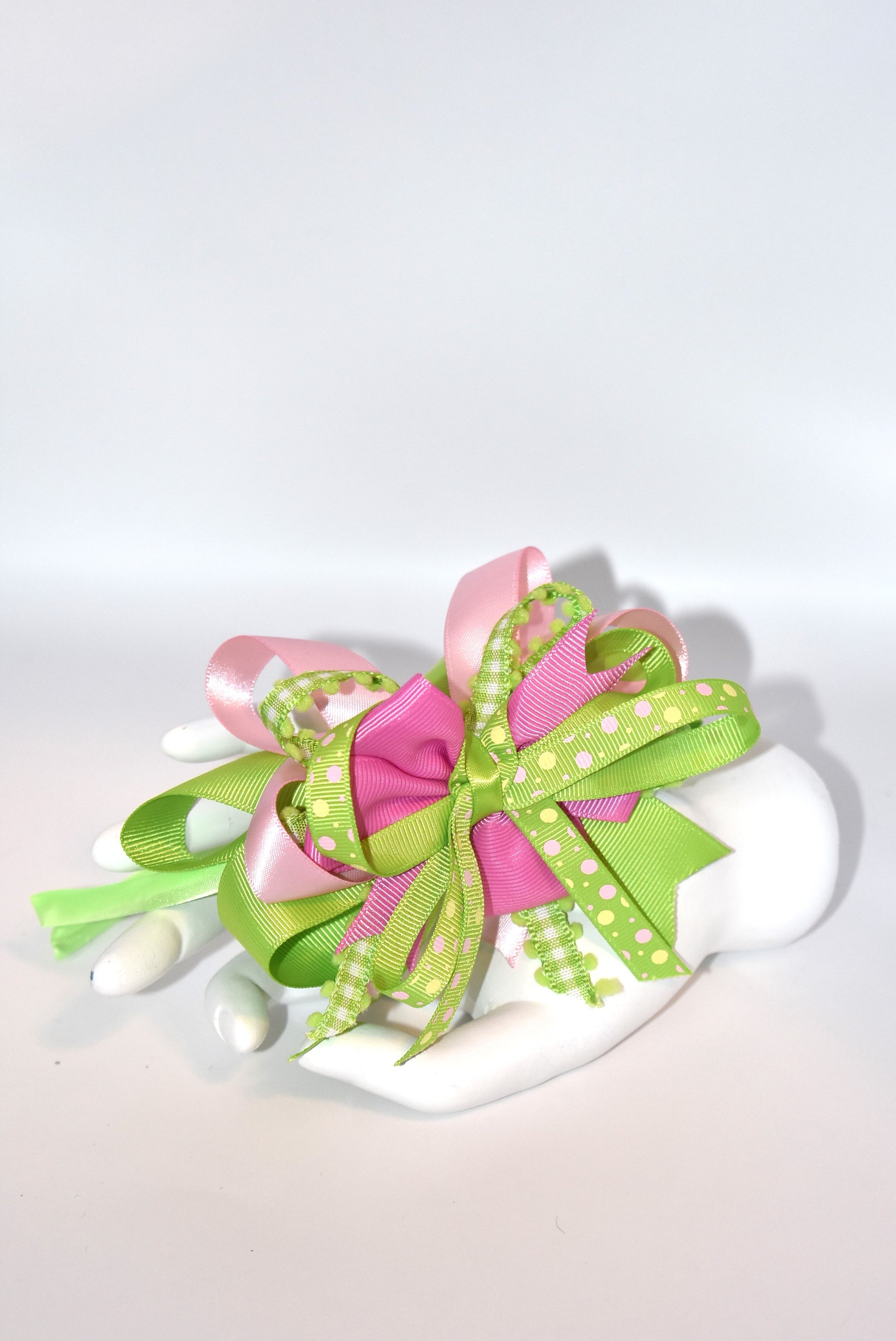Wrap your hair in pure charm with this one-of-a-kind headband! ✨ Featuring delicate layers of pretty ribbon in a gorgeous green and pink color mix, this skinny satin headband is designed for all-day comfort and style. 🎀 Whether you're heading to work, running errands, or enjoying a casual day out, this beauty keeps your look polished without the fuss. 💚💗 Perfect for anyone who loves a pop of color and a touch of whimsy!