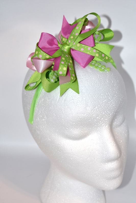 Wrap your hair in pure charm with this one-of-a-kind headband! ✨ Featuring delicate layers of pretty ribbon in a gorgeous green and pink color mix, this skinny satin headband is designed for all-day comfort and style. 🎀 Whether you're heading to work, running errands, or enjoying a casual day out, this beauty keeps your look polished without the fuss. 💚💗 Perfect for anyone who loves a pop of color and a touch of whimsy!