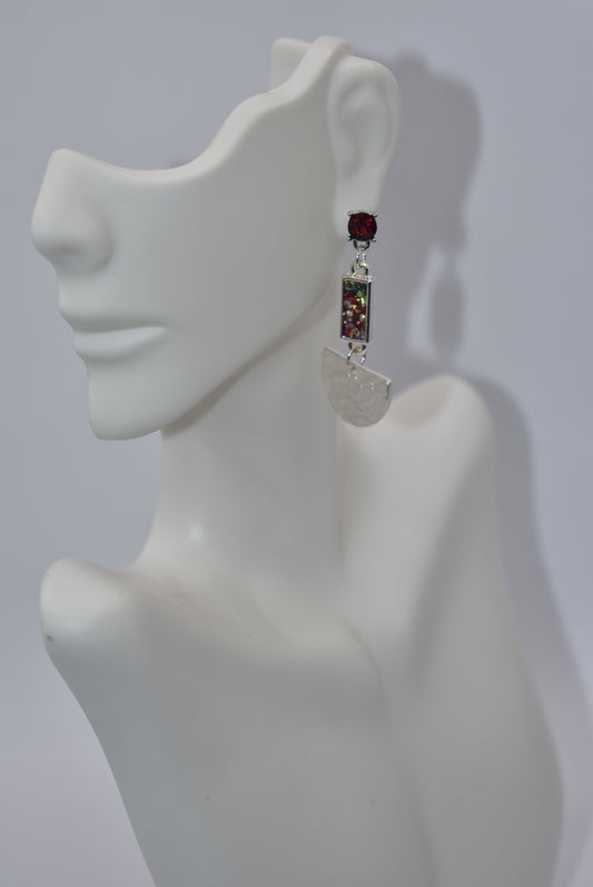 Add a pop of color to your jewelry collection with our Red Collection! Our hypoallergenic gem posts securely hold a multi-colored crushed connector, leading to a half-moon silver hanging piece. Shiny and dazzling, these earrings are sure to make a statement!