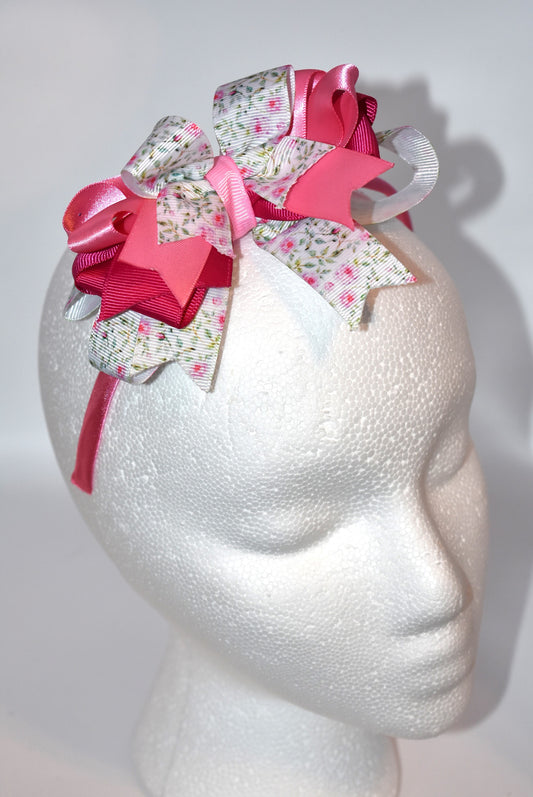 Slip on elegance with this charming pink headband! 💕 Featuring a skinny satin base for comfortable, all-day wear, it's topped with gorgeous layered ribbons that add instant style and sophistication. ✨ Perfect for anyone who loves a touch of feminine flair, this headband combines pretty details with practical design. Whether you're dressing up or keeping it casual, it's your go-to accessory for effortless charm! 🎀