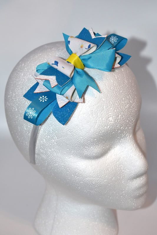 Introducing a headband that's bursting with personality! 🌸 This vibrant floral beauty features layers upon layers of alternating faux leather and satin ribbon, all wrapped around a skinny silhouette for the perfect fit. ✨ The playful mix of textures and eye-catching colors creates a one-of-a-kind accessory that's impossible to resist. 💕 Whether you're dressing up your everyday look or adding flair to a special occasion, this statement piece is sure to become your new favorite. 🎀