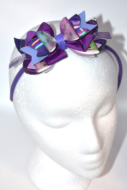 Add a pop of playful purple to your look with this bright satin headband! Thin and comfy, it’s perfect for all ages who love a splash of color. Whether you're young or young at heart, Nana’s Headband Collection 11 is your go-to for fun style and easy wear! 💜✨🎀
