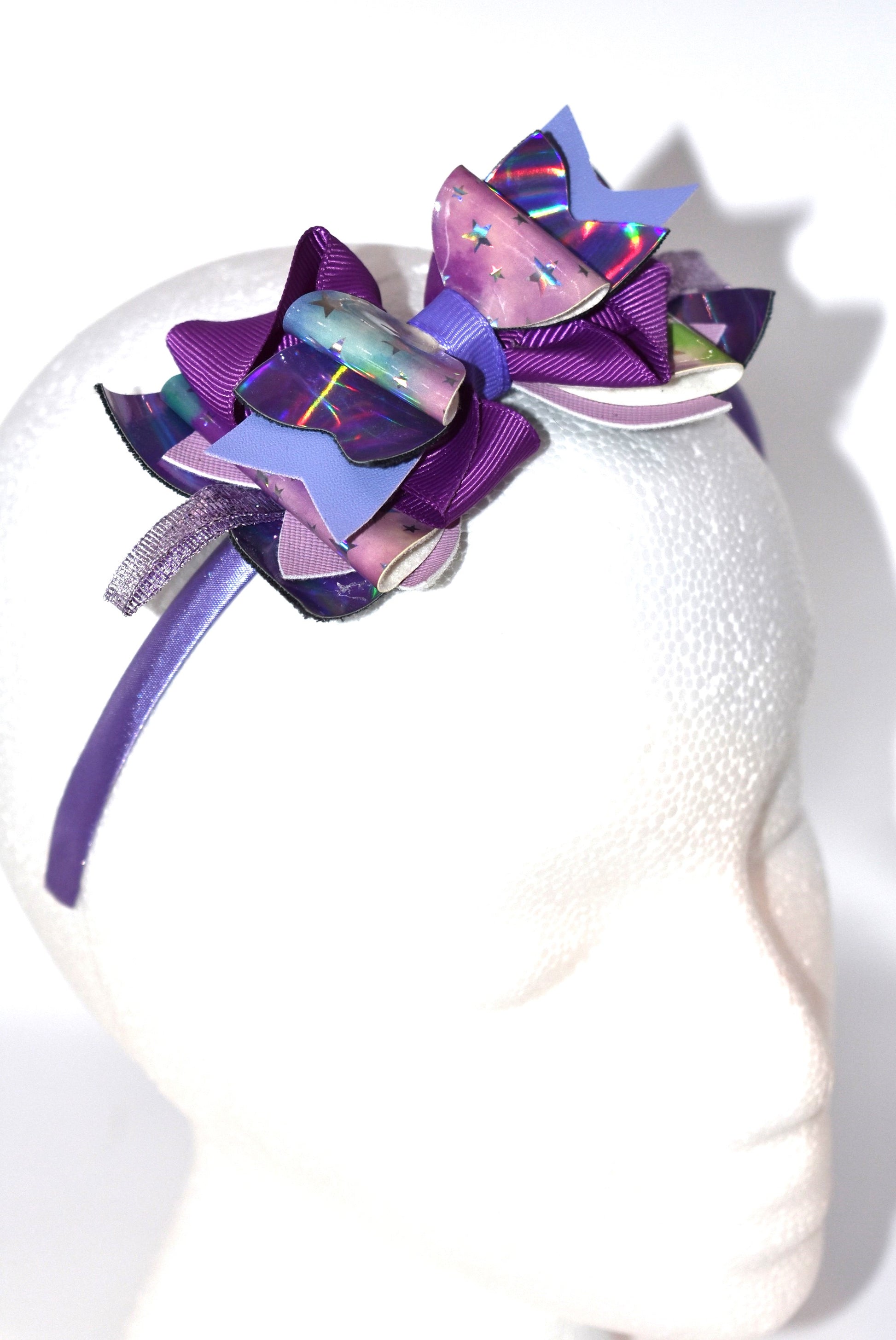 Add a pop of playful purple to your look with this bright satin headband! Thin and comfy, it’s perfect for all ages who love a splash of color. Whether you're young or young at heart, Nana’s Headband Collection 11 is your go-to for fun style and easy wear! 💜✨🎀