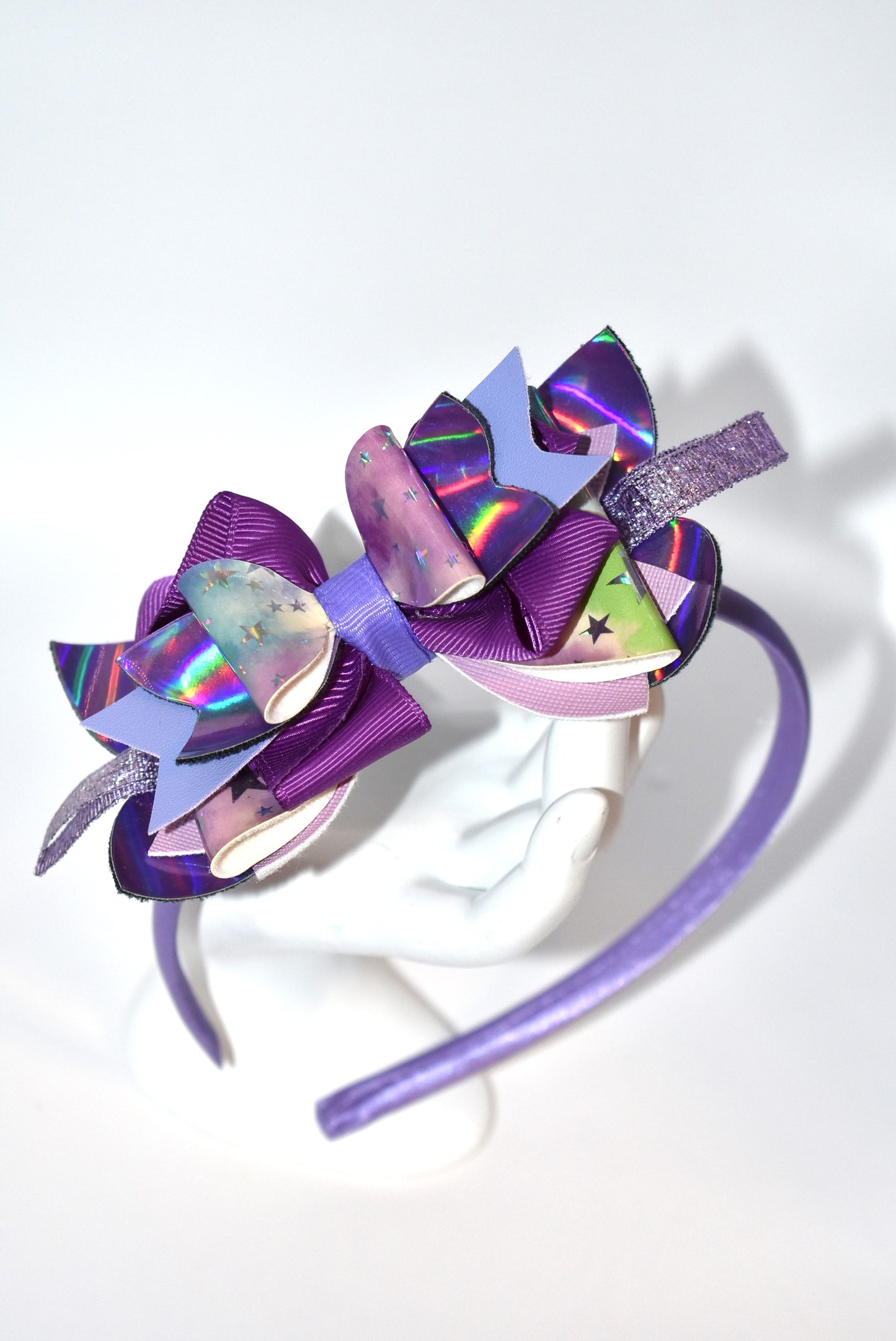 Add a pop of playful purple to your look with this bright satin headband! Thin and comfy, it’s perfect for all ages who love a splash of color. Whether you're young or young at heart, Nana’s Headband Collection 11 is your go-to for fun style and easy wear! 💜✨🎀