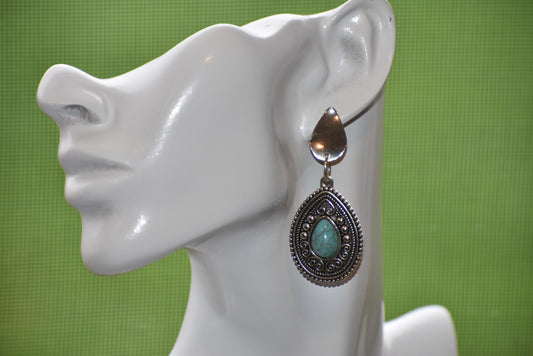 Look no further for an earring set that packs serious western punch! Our Western Collection features beautiful on-the-ear teardrop shaped posts, plated in silver and hypoallergenic. Plus, a pretty turquoise gem is nestled in the middle of a teardrop silver plated fancy charm. Stand out from the crowd!