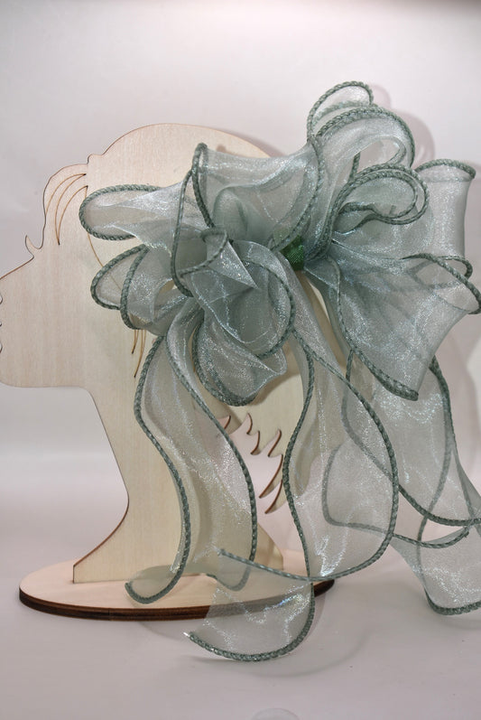 Add a touch of charm with this beautiful sage green long bow, crafted from layers of soft, flowing material. Featuring a wrapped alligator clip, it’s easy to wear and perfect for any age. Whether you’re dressing up or adding a playful twist to your everyday look, this bow brings style and fun wherever you go.