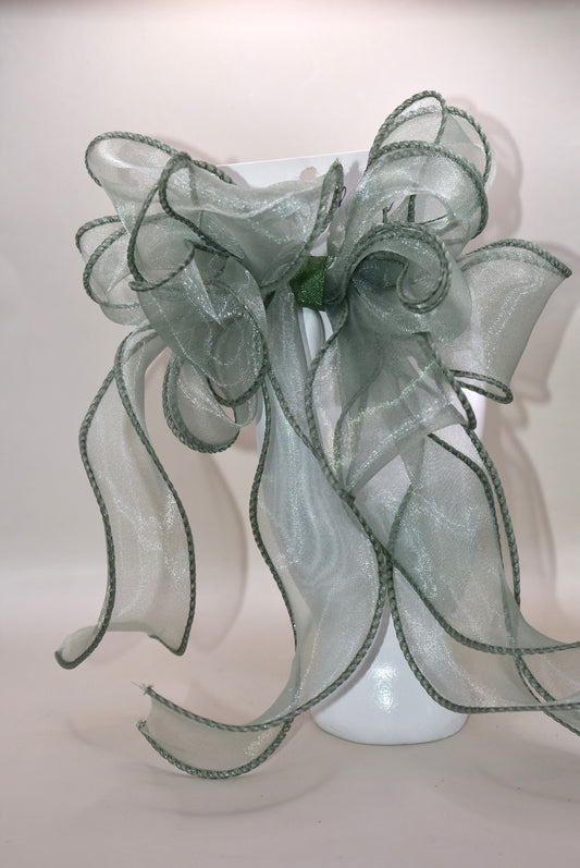 Add a touch of charm with this beautiful sage green long bow, crafted from layers of soft, flowing material. Featuring a wrapped alligator clip, it’s easy to wear and perfect for any age. Whether you’re dressing up or adding a playful twist to your everyday look, this bow brings style and fun wherever you go.