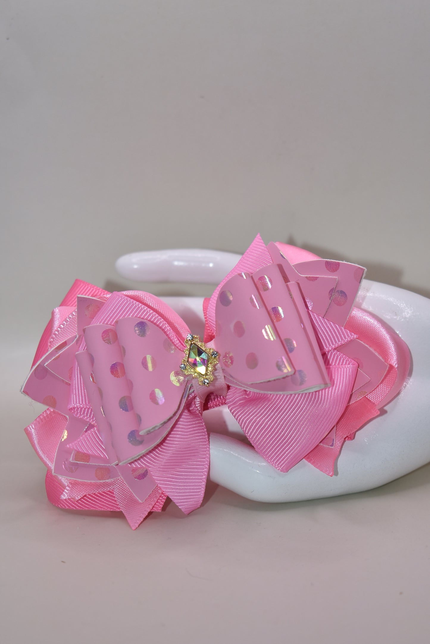 ✨ Introducing Nana's Collection – your new go-to accessory for all things pink and fabulous! 🎀 This charming hair clip features gorgeous layers of soft pink ribbon and faux leather that blend together beautifully, creating the perfect texture mix for any hairstyle. 💕 The wrapped alligator clip keeps your hair secure all day long, while a sparkling charm sits pretty on top, adding that extra touch of glamour. 🌟 Whether you're dressing up or keeping it casual, this sweet accessory brings playful elegance t