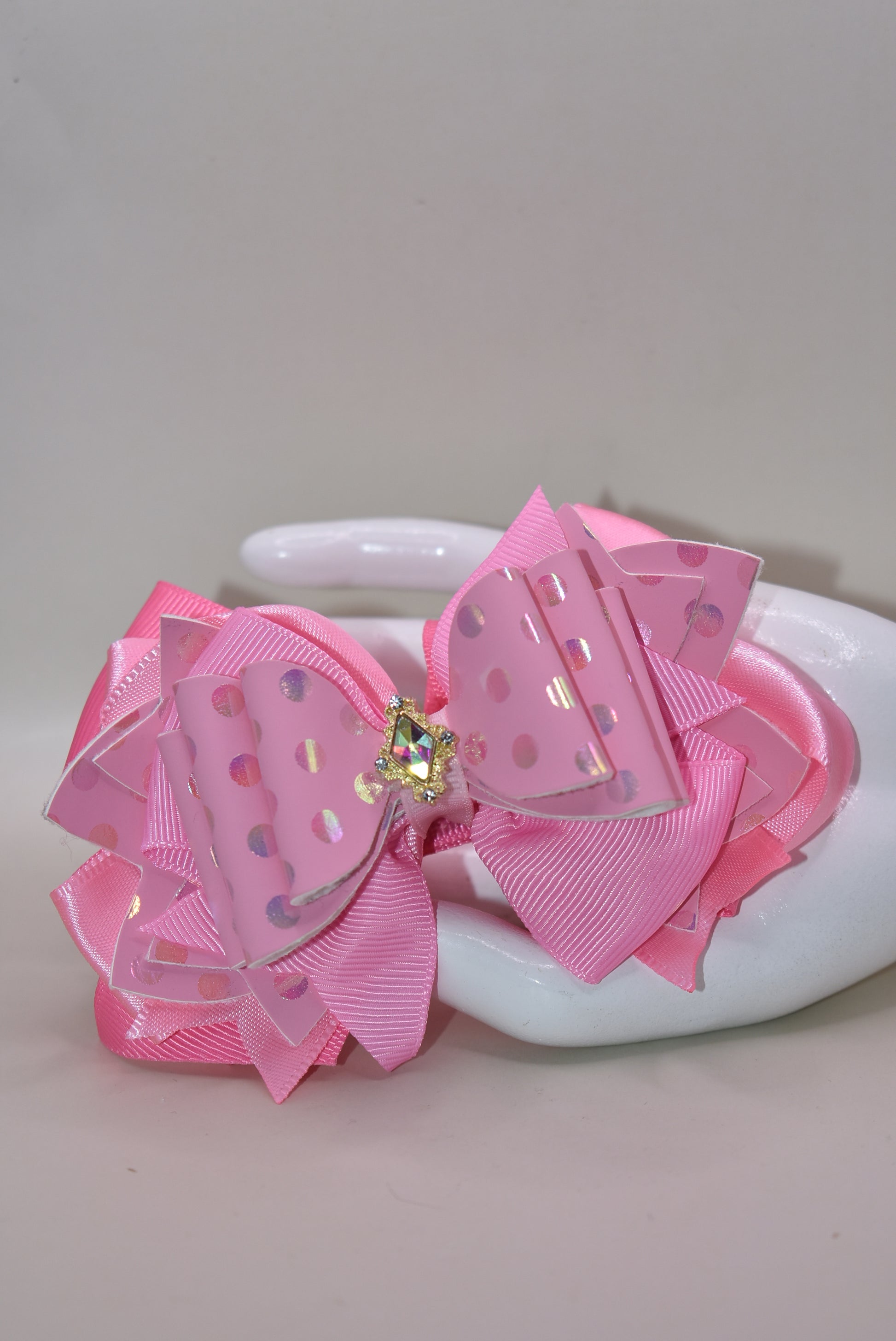 ✨ Introducing Nana's Collection – your new go-to accessory for all things pink and fabulous! 🎀 This charming hair clip features gorgeous layers of soft pink ribbon and faux leather that blend together beautifully, creating the perfect texture mix for any hairstyle. 💕 The wrapped alligator clip keeps your hair secure all day long, while a sparkling charm sits pretty on top, adding that extra touch of glamour. 🌟 Whether you're dressing up or keeping it casual, this sweet accessory brings playful elegance t