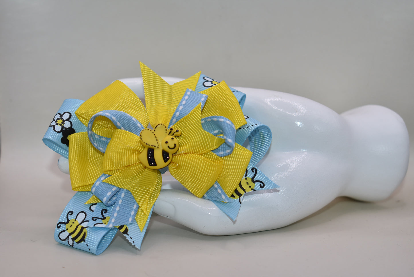 🐝 Introducing the sweetest addition to your little one's accessory collection! This adorable bumble bee bow features delightful layers of ribbon that create texture and charm. Perfect for adding a pop of personality to any outfit, from casual playdates to special occasions. Watch your child's face light up when they see this fun, buzzing accessory! 🎀✨ A playful must-have that brings joy and style together.