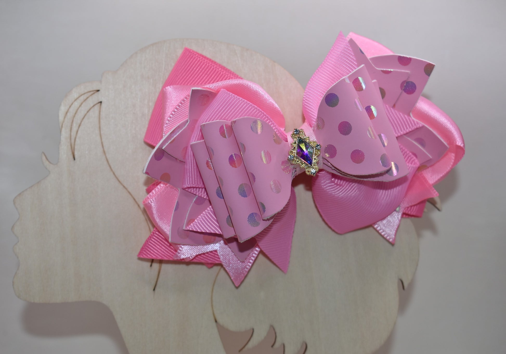 ✨ Introducing Nana's Collection – your new go-to accessory for all things pink and fabulous! 🎀 This charming hair clip features gorgeous layers of soft pink ribbon and faux leather that blend together beautifully, creating the perfect texture mix for any hairstyle. 💕 The wrapped alligator clip keeps your hair secure all day long, while a sparkling charm sits pretty on top, adding that extra touch of glamour. 🌟 Whether you're dressing up or keeping it casual, this sweet accessory brings playful elegance t