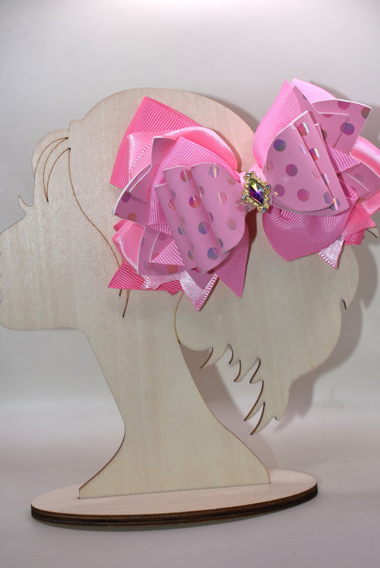 ✨ Introducing Nana's Collection – your new go-to accessory for all things pink and fabulous! 🎀 This charming hair clip features gorgeous layers of soft pink ribbon and faux leather that blend together beautifully, creating the perfect texture mix for any hairstyle. 💕 The wrapped alligator clip keeps your hair secure all day long, while a sparkling charm sits pretty on top, adding that extra touch of glamour. 🌟 Whether you're dressing up or keeping it casual, this sweet accessory brings playful elegance t