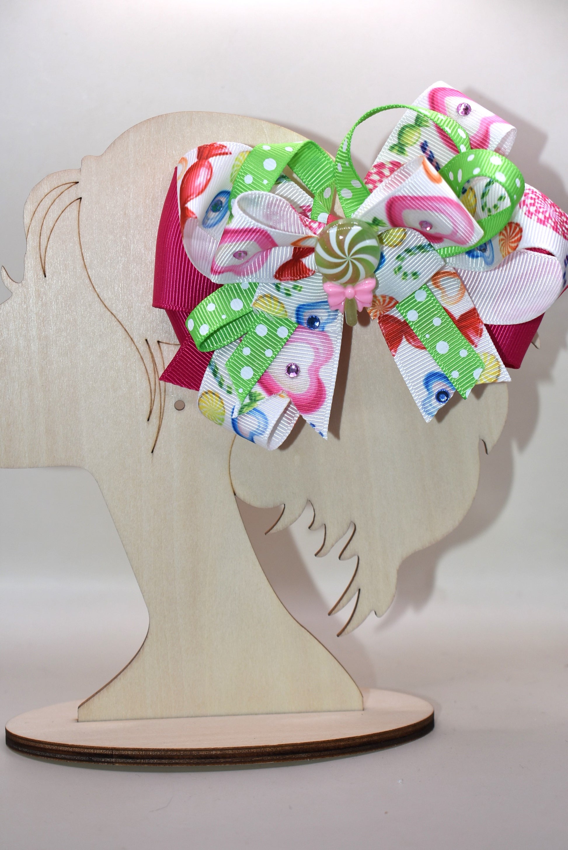 Brighten up your collection with this delightful candy bow charm! 🎀✨ Featuring layers of vibrant, eye-catching ribbon in a rainbow of colors, this playful piece brings instant joy to any accessory collection. Topped with an adorable candy charm that adds a sweet touch of whimsy, it's the perfect way to add a pop of color and fun to your style. 🍬💖 From Nana's Collection, because life's too short for boring accessories!