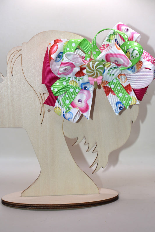 Brighten up your collection with this delightful candy bow charm! 🎀✨ Featuring layers of vibrant, eye-catching ribbon in a rainbow of colors, this playful piece brings instant joy to any accessory collection. Topped with an adorable candy charm that adds a sweet touch of whimsy, it's the perfect way to add a pop of color and fun to your style. 🍬💖 From Nana's Collection, because life's too short for boring accessories!