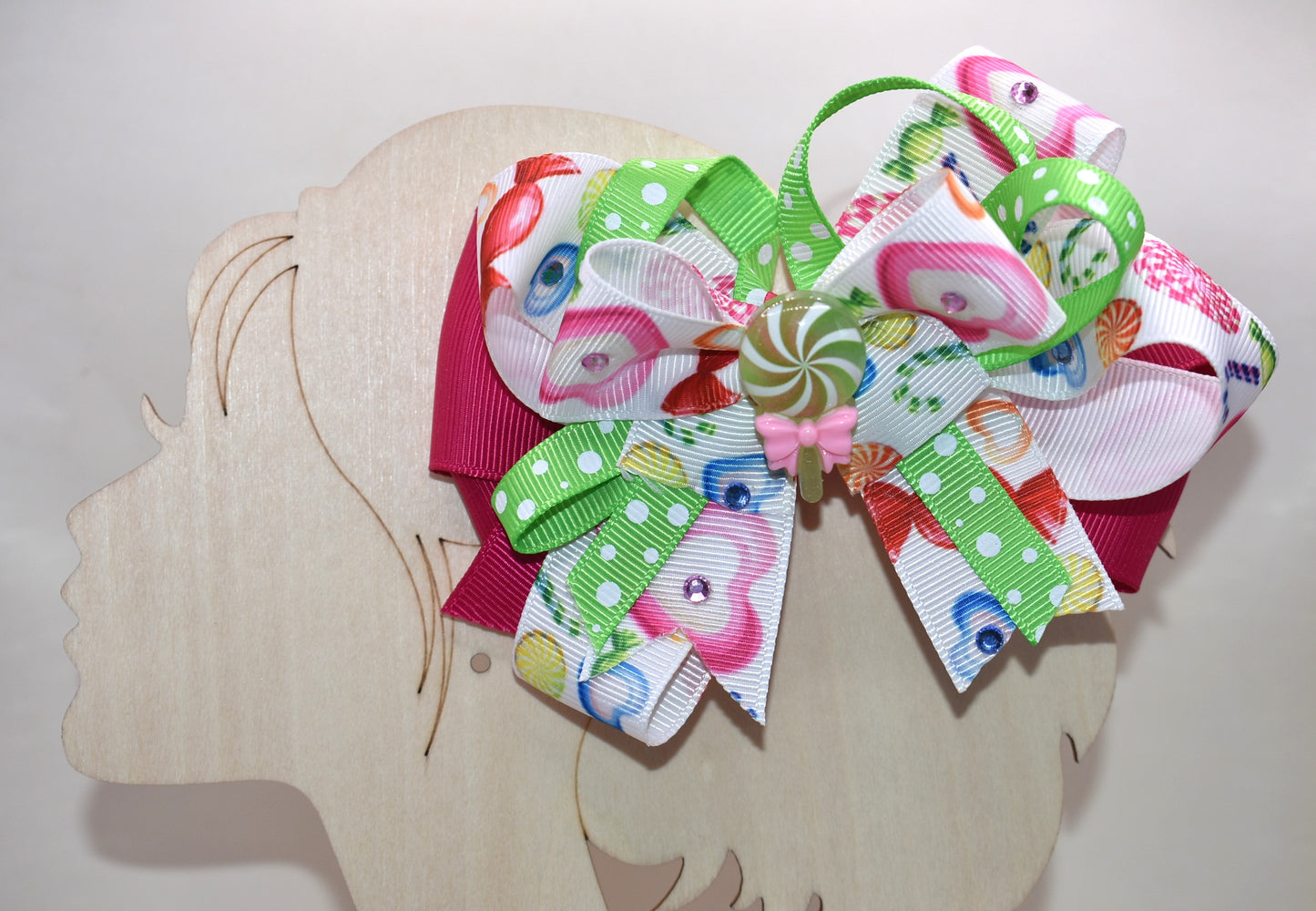 Brighten up your collection with this delightful candy bow charm! 🎀✨ Featuring layers of vibrant, eye-catching ribbon in a rainbow of colors, this playful piece brings instant joy to any accessory collection. Topped with an adorable candy charm that adds a sweet touch of whimsy, it's the perfect way to add a pop of color and fun to your style. 🍬💖 From Nana's Collection, because life's too short for boring accessories!