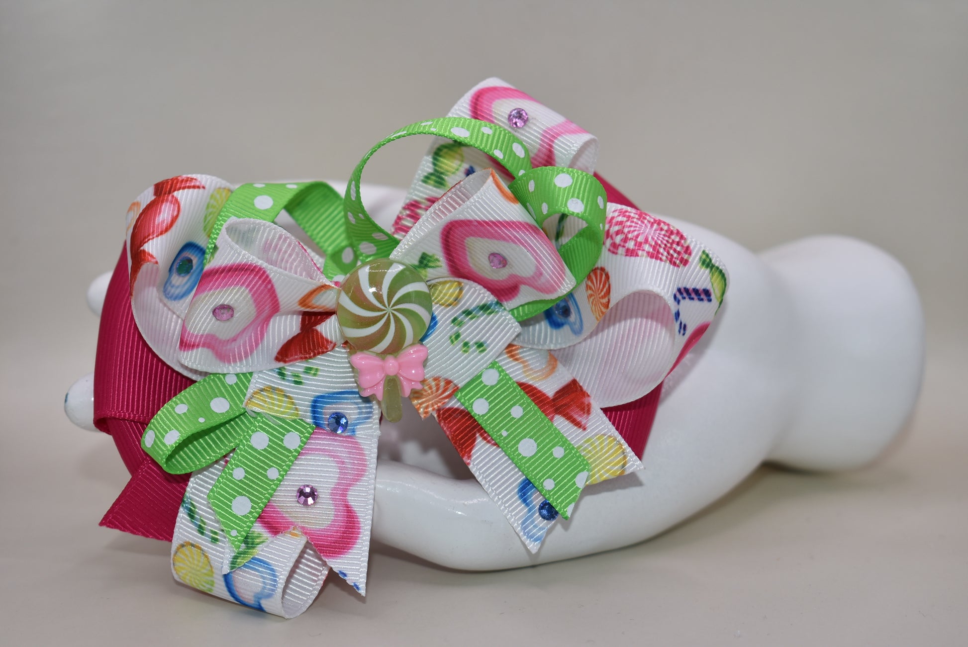 Brighten up your collection with this delightful candy bow charm! 🎀✨ Featuring layers of vibrant, eye-catching ribbon in a rainbow of colors, this playful piece brings instant joy to any accessory collection. Topped with an adorable candy charm that adds a sweet touch of whimsy, it's the perfect way to add a pop of color and fun to your style. 🍬💖 From Nana's Collection, because life's too short for boring accessories!