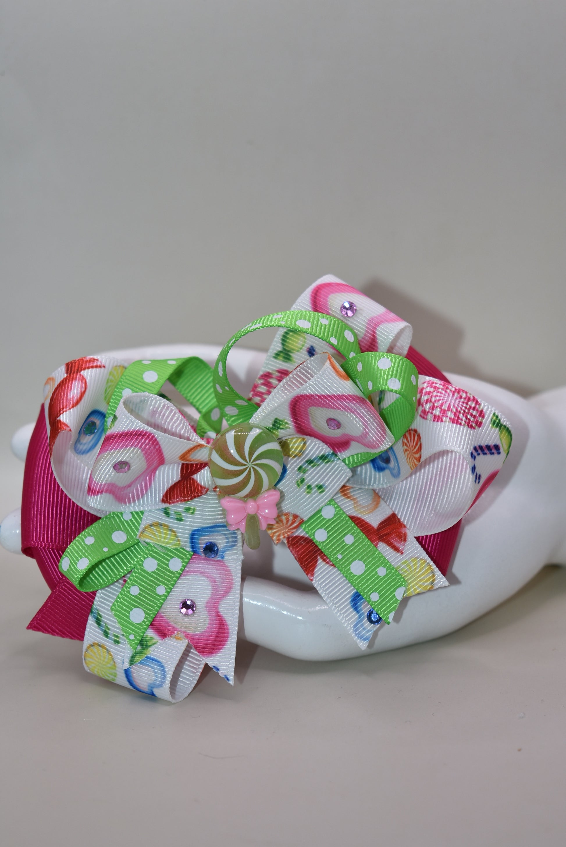 Brighten up your collection with this delightful candy bow charm! 🎀✨ Featuring layers of vibrant, eye-catching ribbon in a rainbow of colors, this playful piece brings instant joy to any accessory collection. Topped with an adorable candy charm that adds a sweet touch of whimsy, it's the perfect way to add a pop of color and fun to your style. 🍬💖 From Nana's Collection, because life's too short for boring accessories!