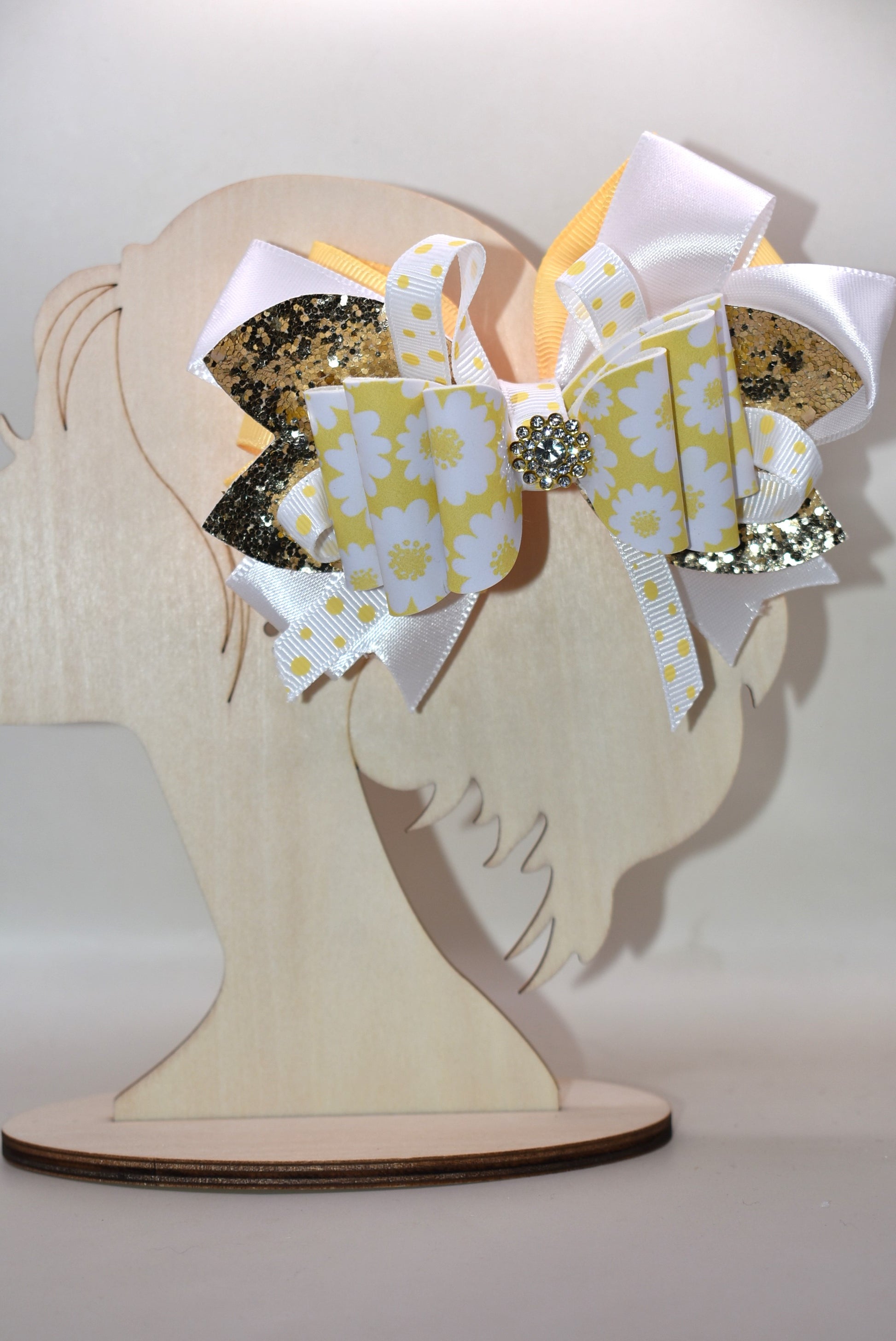 ✨ Brighten up any look with this cheerful bow featuring vibrant yellow and white ribbon paired with shimmering gold glitter faux leather! 🎀 The perfect pop of fun that works with whatever you're wearing—casual or dressed up, this accessory is your go-to style companion. 💛 Secured with a wrapped alligator clip on the back for effortless, all-day wear. 🌟