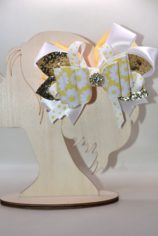 ✨ Brighten up any look with this cheerful bow featuring vibrant yellow and white ribbon paired with shimmering gold glitter faux leather! 🎀 The perfect pop of fun that works with whatever you're wearing—casual or dressed up, this accessory is your go-to style companion. 💛 Secured with a wrapped alligator clip on the back for effortless, all-day wear. 🌟