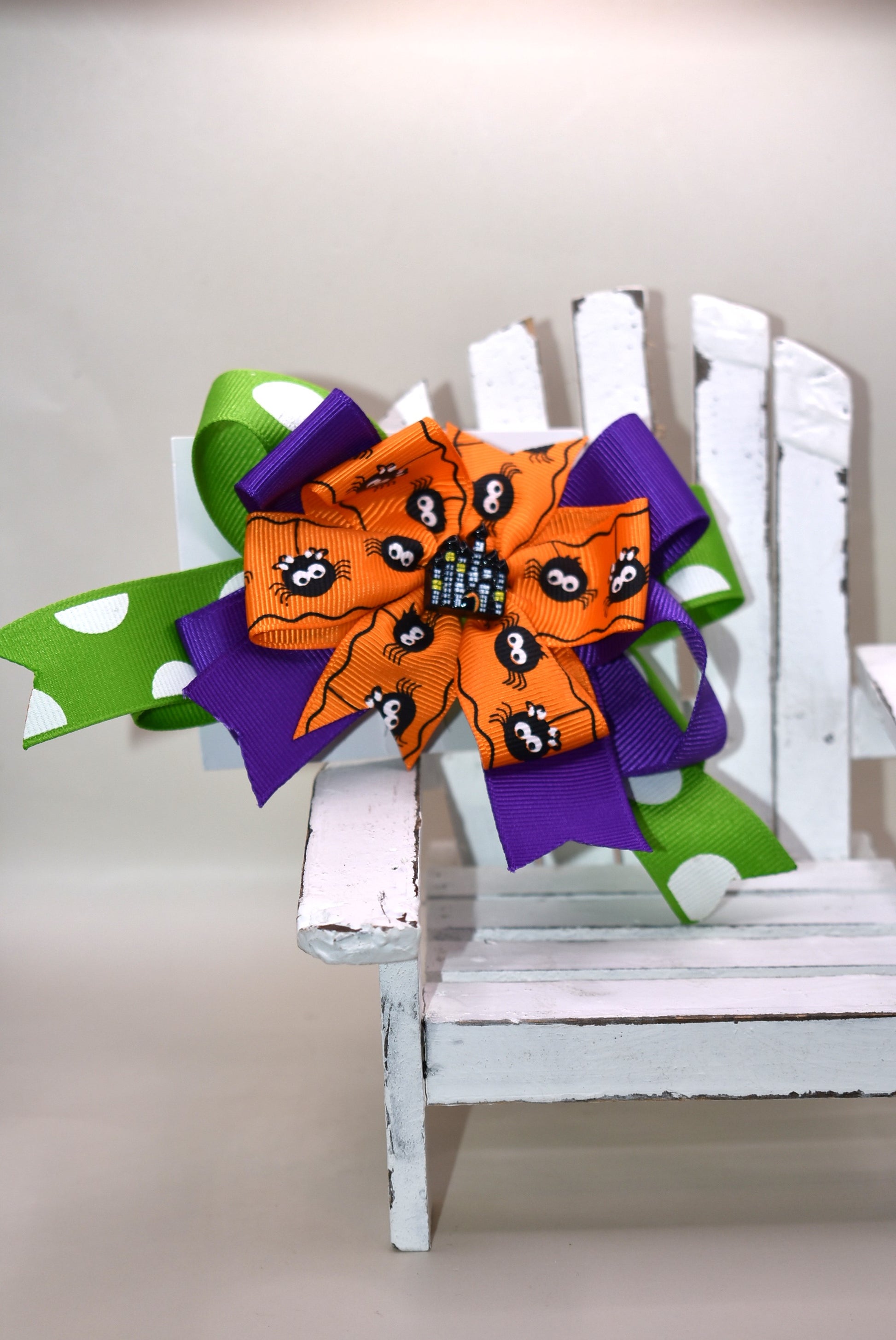 Get into the spooky spirit with this Halloween bow featuring a bold green polka dot ribbon and a charming spider ribbon 🕷️. Topped with an adorable haunted house charm 🏚️, it's the perfect festive accessory. Easy to wear with a wrapped alligator clip on the back — just clip and go! 🎃👻