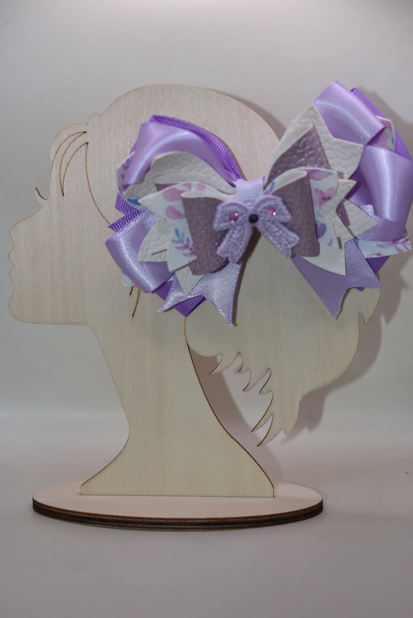 Bow lovers, rejoice! 🎀 This stunning creation features luxurious layers of ribbon and faux leather that build the perfect foundation. Topped with an adorable crocheted lavender bow adorned with sparkles ✨ for that extra touch of magic, this accessory is pure charm. The wrapped alligator clip ensures a secure, all-day hold so you can strut your stuff without worry. Perfect for adding a playful pop of personality to any look! 💜