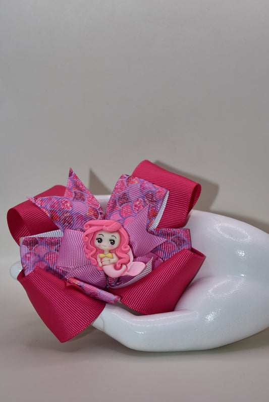 ive into mermaid magic with this one-of-a-kind hot pink mermaid bow! 🧜♀️✨ Adorable and stylish, it's the perfect accessory to make any outfit pop. 💕 Featuring a wrapped alligator clip for effortless wear, this charming piece from Nana's Collection keeps your hair secured in fabulous fashion all day long. 🎀 Whether you're channeling your inner ocean lover or just want to add a splash of playful color, this bow is your new go-to accessory! 🌊💖