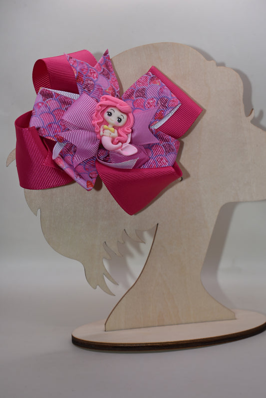 ive into mermaid magic with this one-of-a-kind hot pink mermaid bow! 🧜♀️✨ Adorable and stylish, it's the perfect accessory to make any outfit pop. 💕 Featuring a wrapped alligator clip for effortless wear, this charming piece from Nana's Collection keeps your hair secured in fabulous fashion all day long. 🎀 Whether you're channeling your inner ocean lover or just want to add a splash of playful color, this bow is your new go-to accessory! 🌊💖