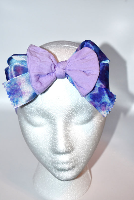 Add a splash of fun with this beautiful light purple wide headband! Featuring a pretty purple tie-dye ribbon right in the middle, it’s super soft and comfy for all-day wear. Perfect for brightening your look with a playful twist! 💜✨🎀