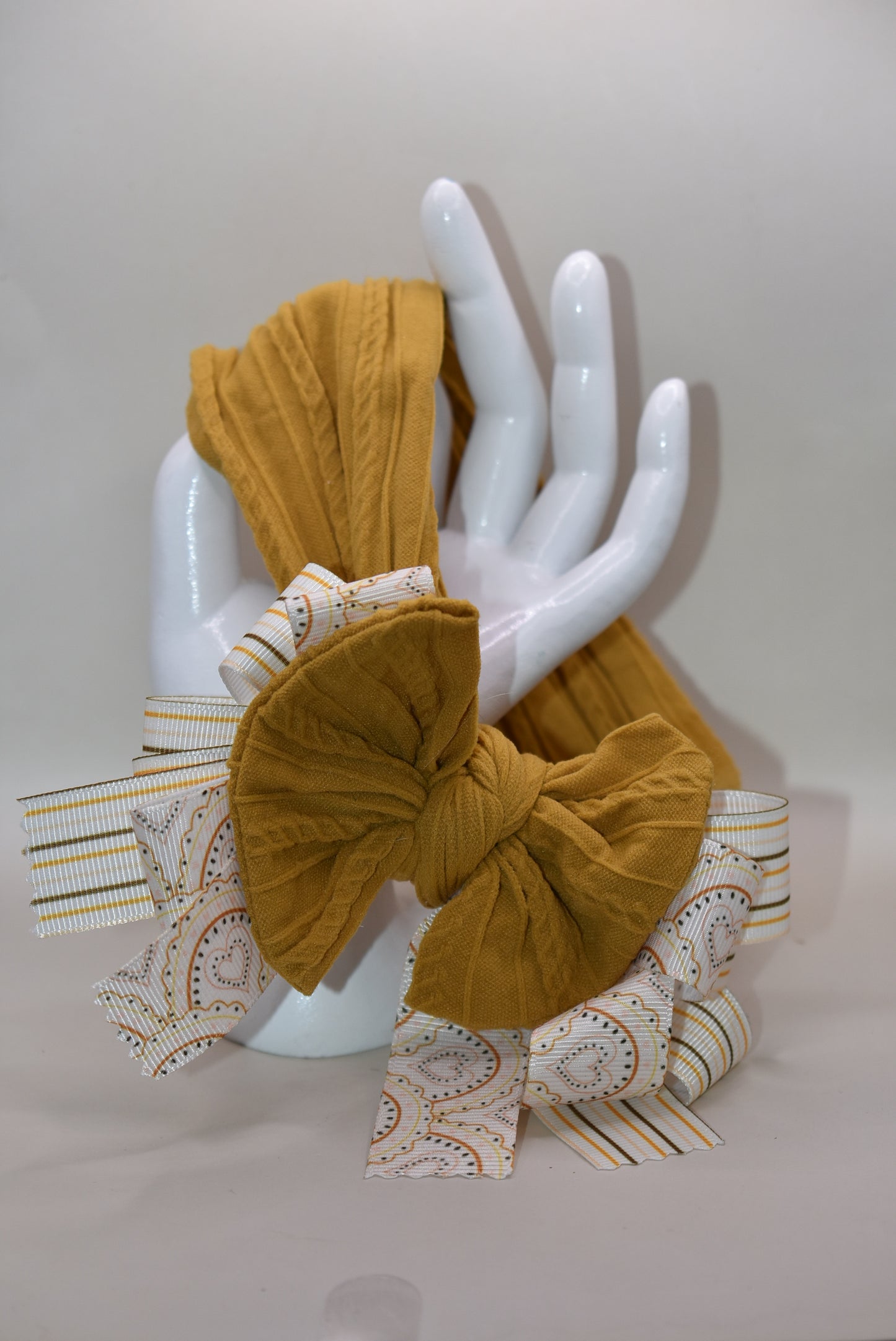 Add a touch of charm with this soft brown headband 🎀 featuring layered striped and heart ribbons for a fun, dimensional look. Cozy and comfy, it’s perfect for all ages to wear and play! 🌟