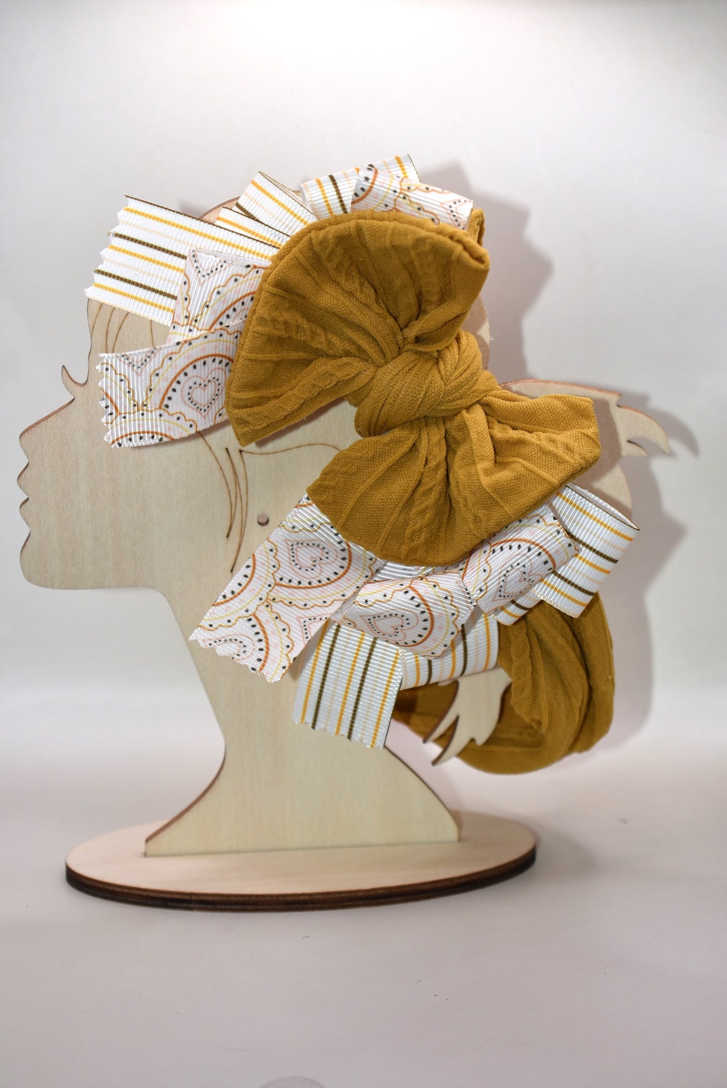 Add a touch of charm with this soft brown headband 🎀 featuring layered striped and heart ribbons for a fun, dimensional look. Cozy and comfy, it’s perfect for all ages to wear and play! 🌟