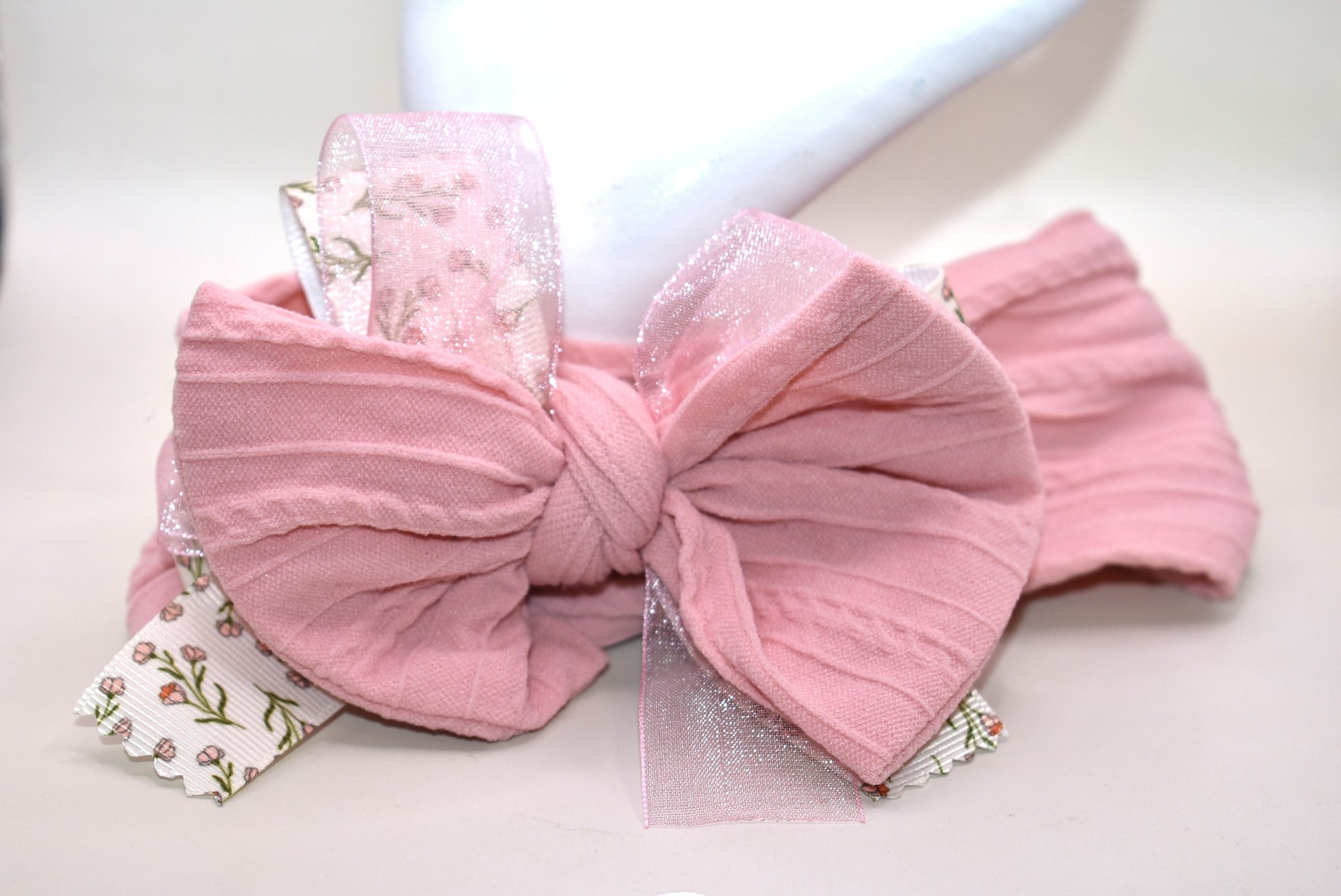 Add a touch of sweetness with this soft blush pink headband, featuring a delicate floral ribbon centerpiece and a gentle baby pink chiffon accent. It's the perfect playful accessory for all ages to brighten up any outfit with a soft, pretty vibe. 🌸🎀💕