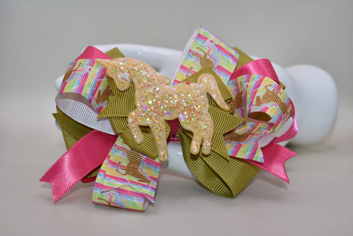 ✨ Get ready to turn heads with this absolutely magical unicorn bow! 🦄 Featuring an adorable, eye-catching gold unicorn patch perched on top of layered ribbon, this bow is pure fun and flair. The wrapped alligator clip makes it super easy to clip in and go—no fussing required! 💛 Perfect for adding a touch of whimsy and sparkle to any hairstyle. Whether you're heading to a party or just want to brighten your day, this playful accessory delivers instant charm and personality. 🎀