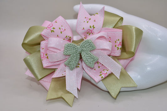 Add some fun and flair to your look with Nana's Collection 39! Featuring a playful mix of sage green and pink ribbons, topped with a cute crochet bow on a polka dot ribbon. Multiple layers of mixed ribbon make it an eye-catching accessory. Comes with a wrapped alligator clip for easy use.