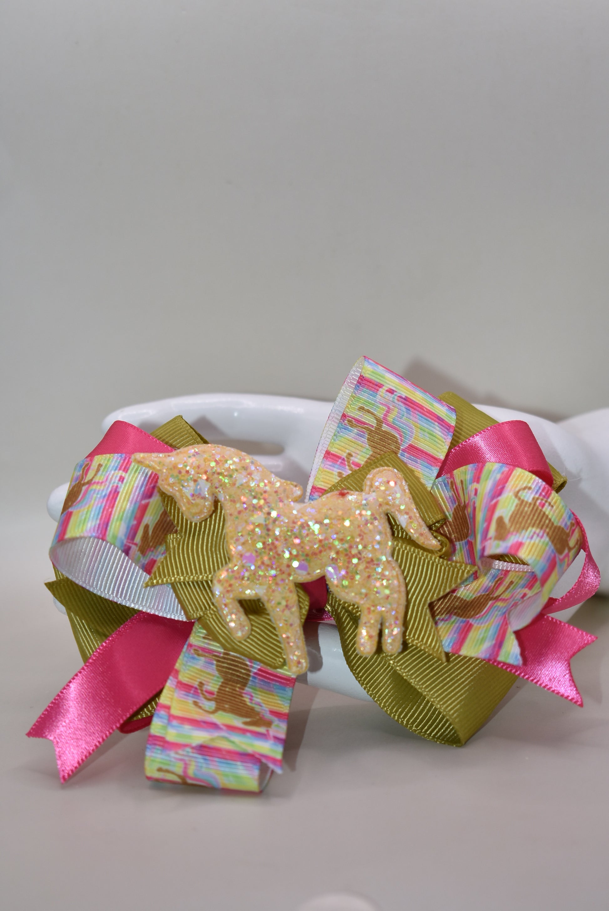 ✨ Get ready to turn heads with this absolutely magical unicorn bow! 🦄 Featuring an adorable, eye-catching gold unicorn patch perched on top of layered ribbon, this bow is pure fun and flair. The wrapped alligator clip makes it super easy to clip in and go—no fussing required! 💛 Perfect for adding a touch of whimsy and sparkle to any hairstyle. Whether you're heading to a party or just want to brighten your day, this playful accessory delivers instant charm and personality. 🎀