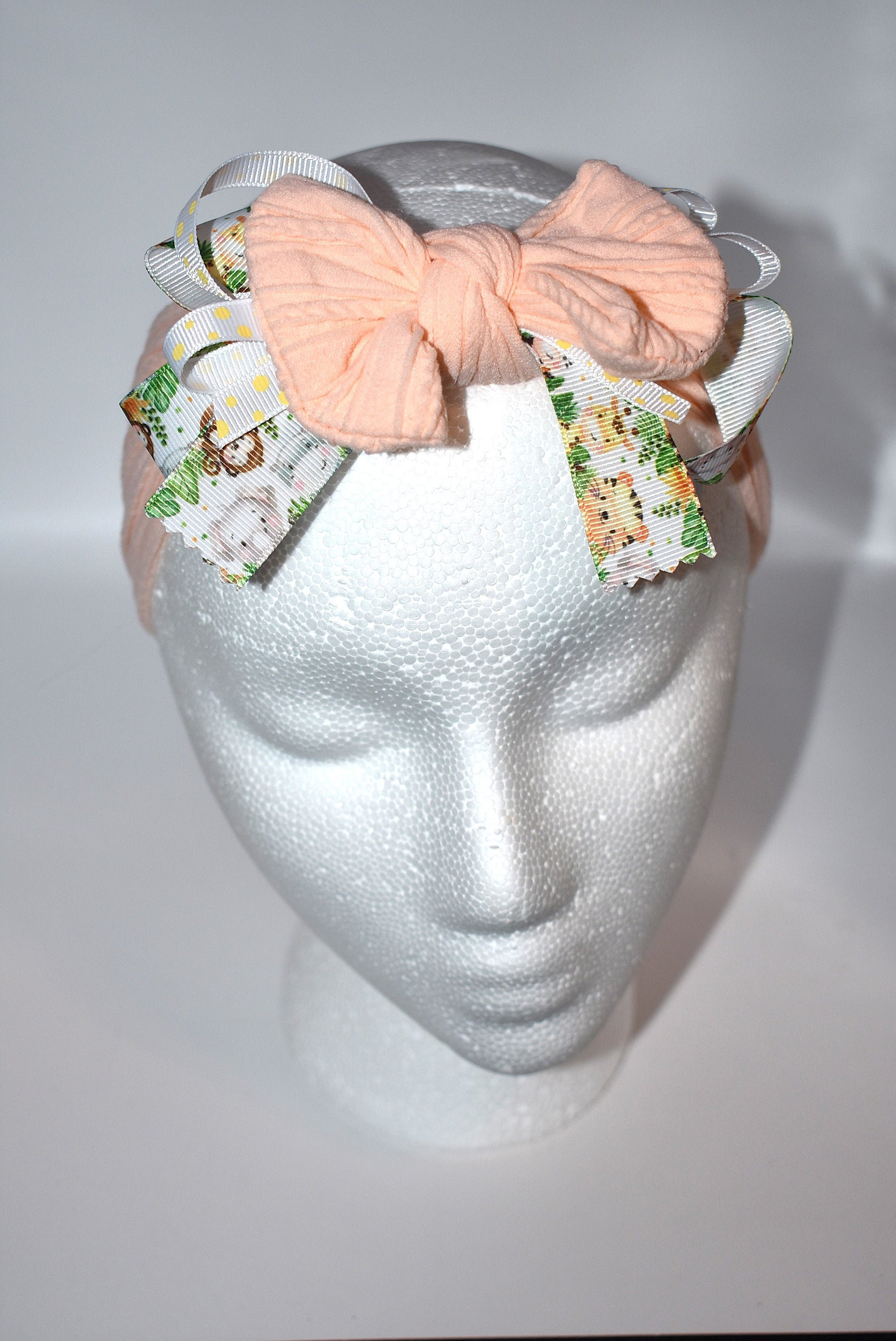 Add a splash of fun to your look with this wrapped headband featuring a super cute animal print ribbon blended with soft peach fabric. This one-of-a-kind piece is perfect for brightening your day and keeping hair stylishly in place. 🐾🍑✨