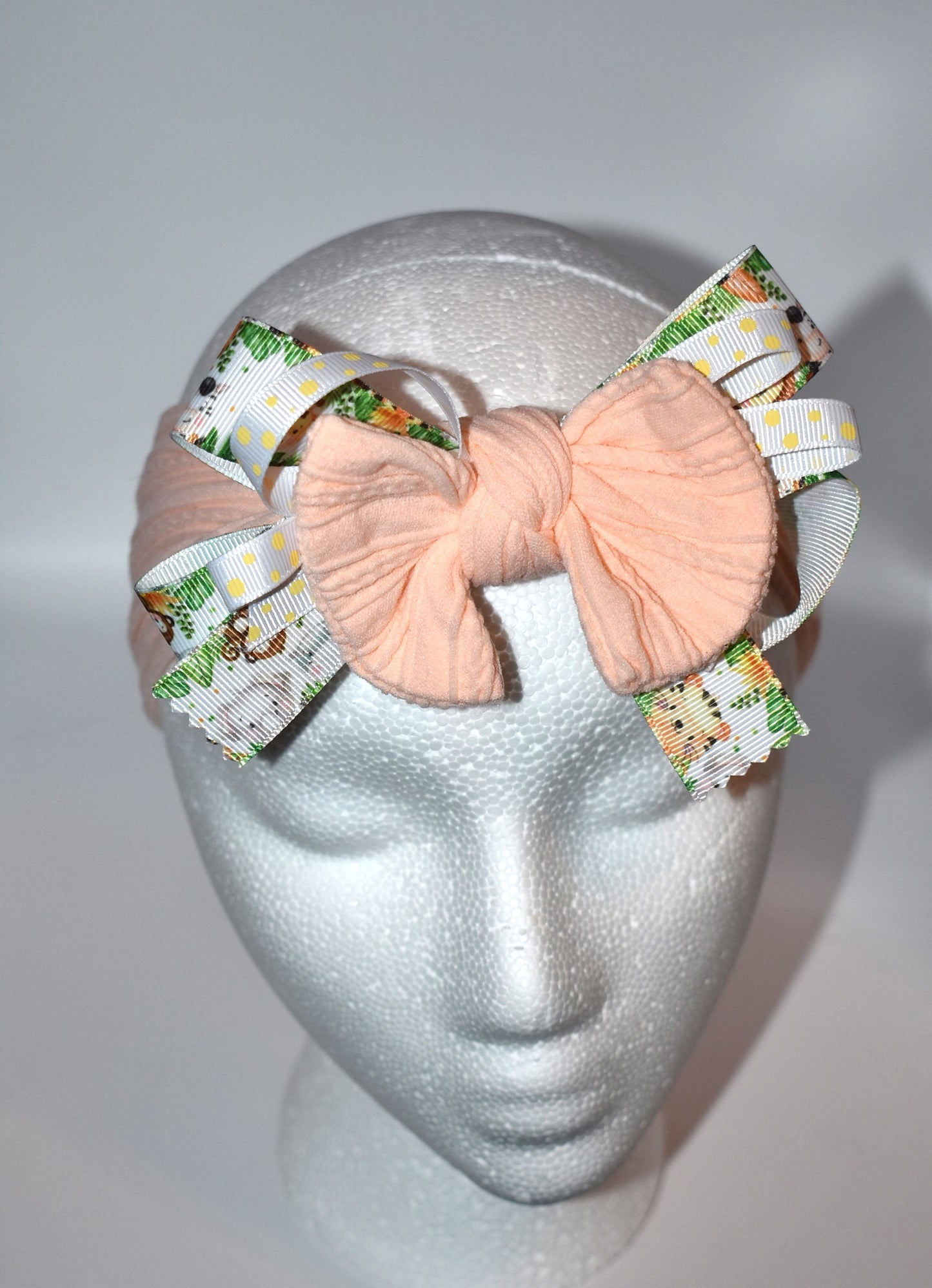Add a splash of fun to your look with this wrapped headband featuring a super cute animal print ribbon blended with soft peach fabric. This one-of-a-kind piece is perfect for brightening your day and keeping hair stylishly in place. 🐾🍑✨