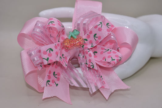 Nana's Collection 42: Add some sweet style to any outfit with the perfect cherry bow! Featuring baby pink ribbons and a sparkly cherry on top, this alligator clip ensures comfort and cuteness all day long.