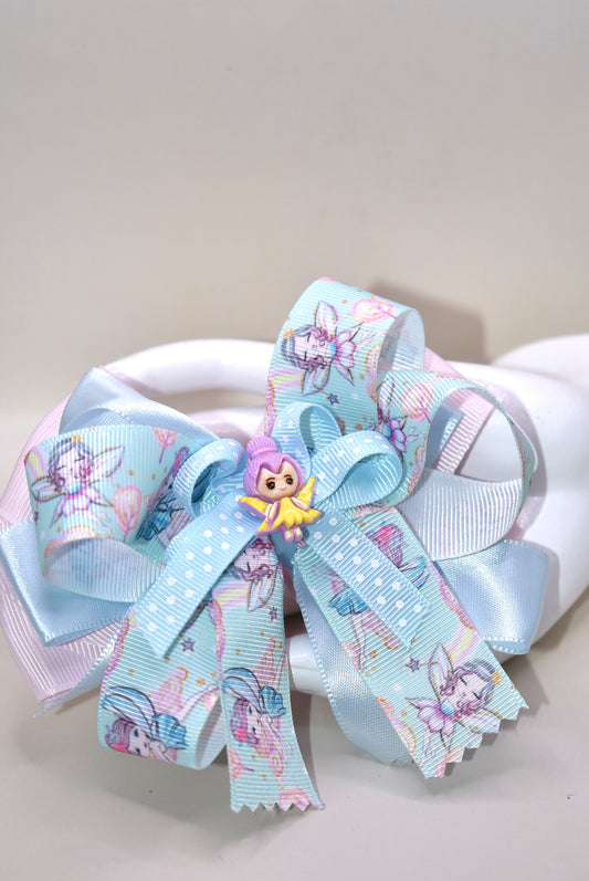 Add a touch of whimsy to any outfit with Nana's Collection 30! This darling fairy bow is made of layers of satin and grosgrain material, sure to catch the eye. Complete with a fairy ribbon and charming fairy charm, and an alligator clip for all-day comfort. Love at first sight!