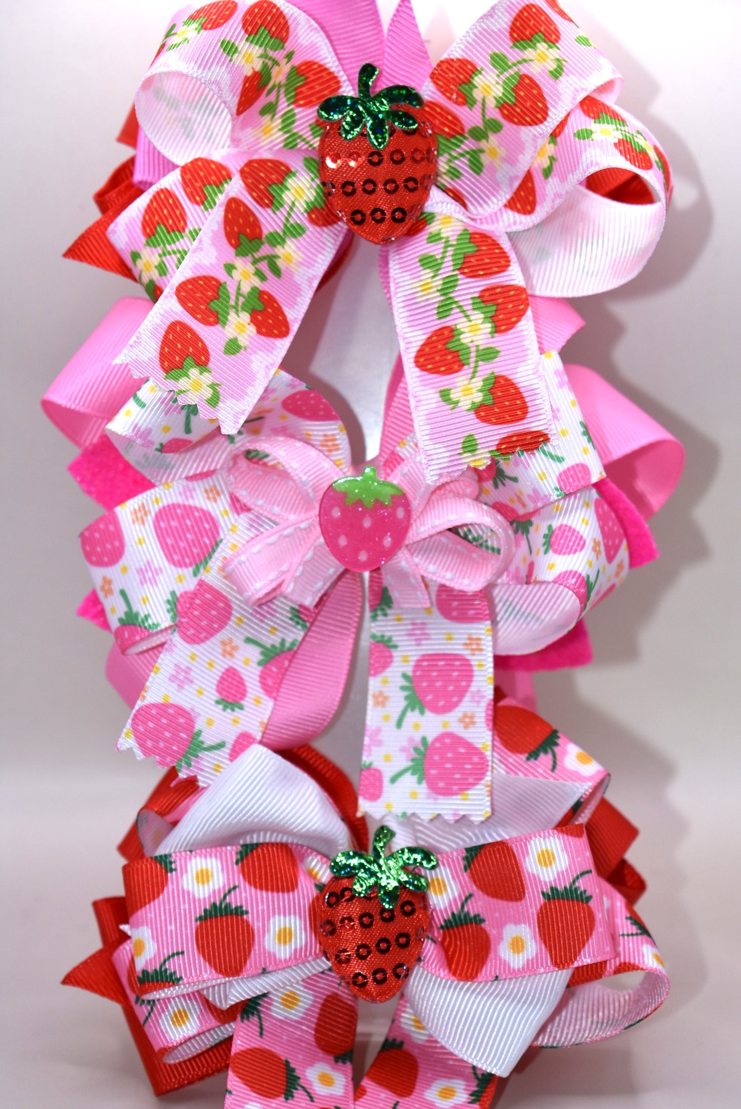 Fall in love with Nana's Collection 55! This sweet strawberry bow is perfect for summertime fun and comes with an alligator clip for a secure and comfortable fit. Your little one will be sure to adore this playful and stylish accessory.