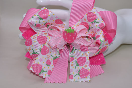 Fall in love with Nana's Collection 55! This sweet strawberry bow is perfect for summertime fun and comes with an alligator clip for a secure and comfortable fit. Your little one will be sure to adore this playful and stylish accessory.