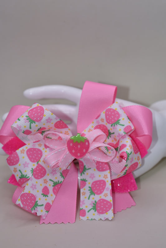 Fall in love with Nana's Collection 55! This sweet strawberry bow is perfect for summertime fun and comes with an alligator clip for a secure and comfortable fit. Your little one will be sure to adore this playful and stylish accessory.