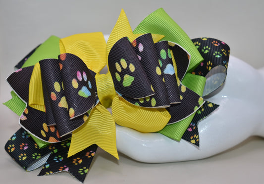 Adorable paw print faux leather bow featuring vibrant, mixed colors that pop! 🐾✨ This charming accessory pairs perfectly with any outfit and any vibe you're going for. The wrapped alligator clip makes it super easy to clip and go, so you can switch up your look in seconds. 🎀 Whether you're dressing up or keeping it casual, this cute bow adds that perfect finishing touch! 💕