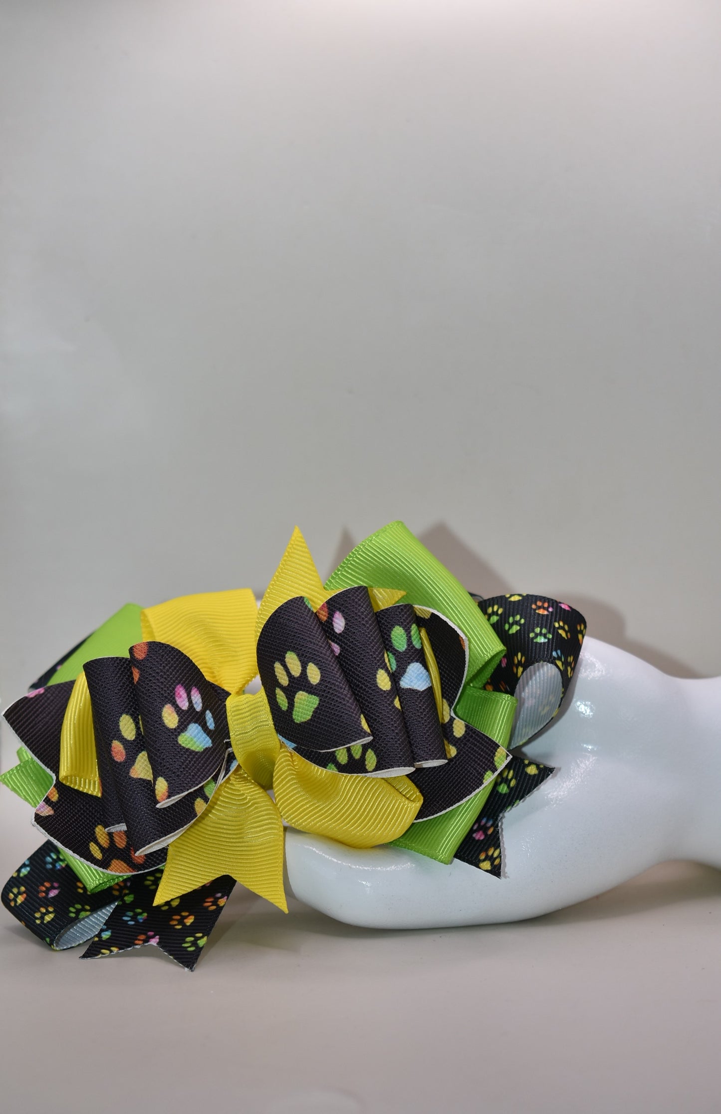Adorable paw print faux leather bow featuring vibrant, mixed colors that pop! 🐾✨ This charming accessory pairs perfectly with any outfit and any vibe you're going for. The wrapped alligator clip makes it super easy to clip and go, so you can switch up your look in seconds. 🎀 Whether you're dressing up or keeping it casual, this cute bow adds that perfect finishing touch! 💕