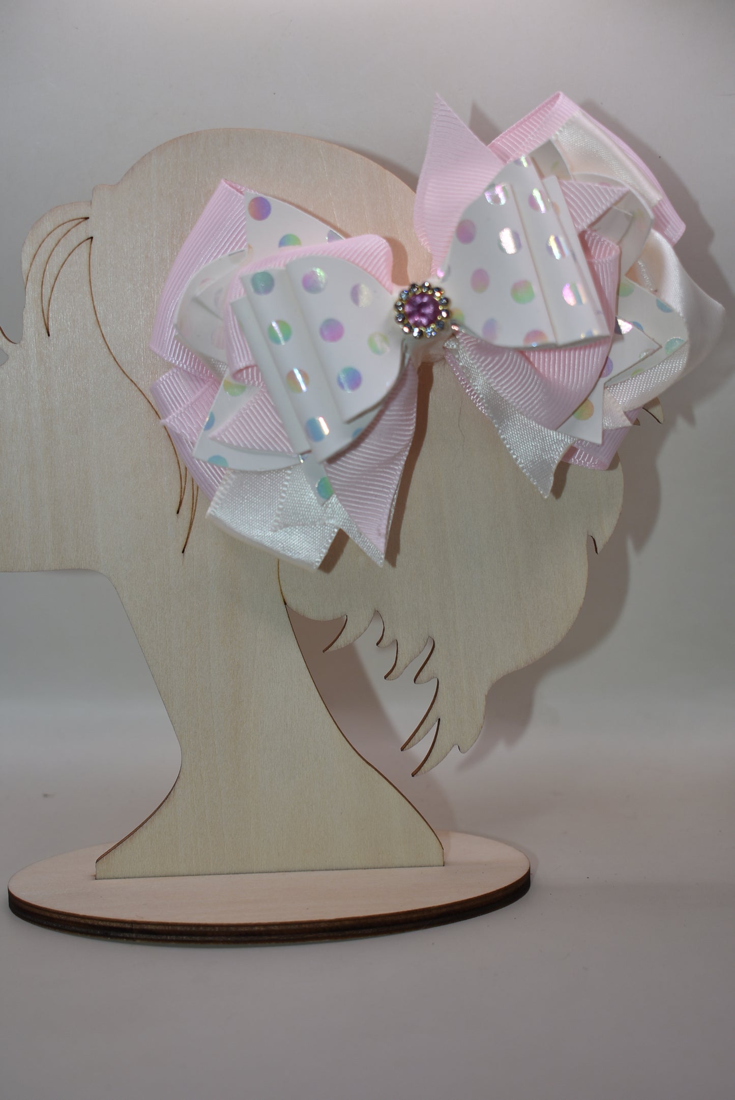 ✨ Introducing the prettiest pink bow that'll make any little girl's heart skip a beat! 💕 This adorable accessory features layers upon layers of luxurious ribbon and faux leather, creating a dimensional look that's absolutely stunning. Whether you're dressing up for a special occasion or adding a touch of charm to everyday wear, this versatile bow does it all. 👑 The sparkling crystal charm perched on top adds that extra dash of magic and elegance. Each piece is truly one-of-a-kind, making it a special trea