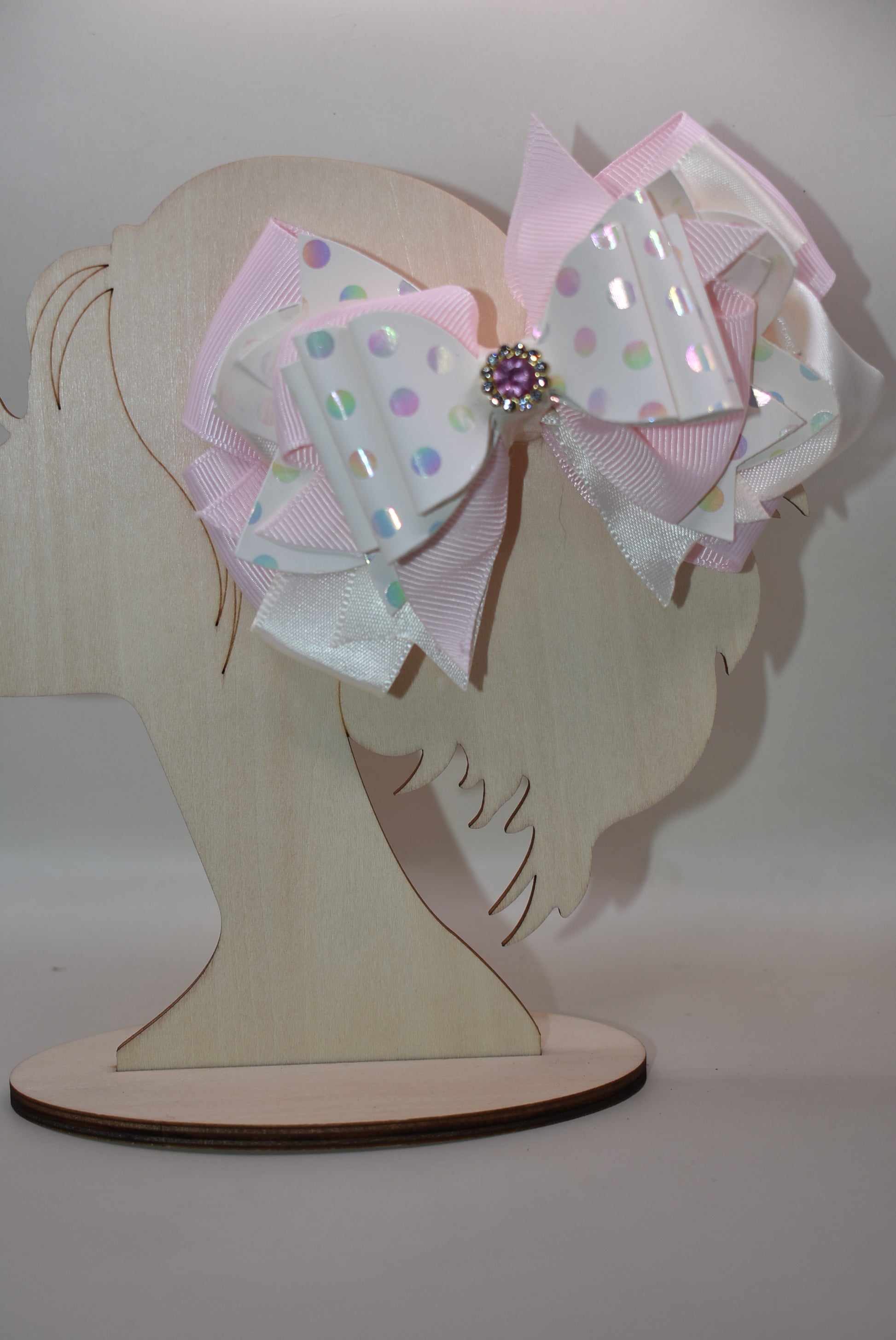 ✨ Introducing the prettiest pink bow that'll make any little girl's heart skip a beat! 💕 This adorable accessory features layers upon layers of luxurious ribbon and faux leather, creating a dimensional look that's absolutely stunning. Whether you're dressing up for a special occasion or adding a touch of charm to everyday wear, this versatile bow does it all. 👑 The sparkling crystal charm perched on top adds that extra dash of magic and elegance. Each piece is truly one-of-a-kind, making it a special trea