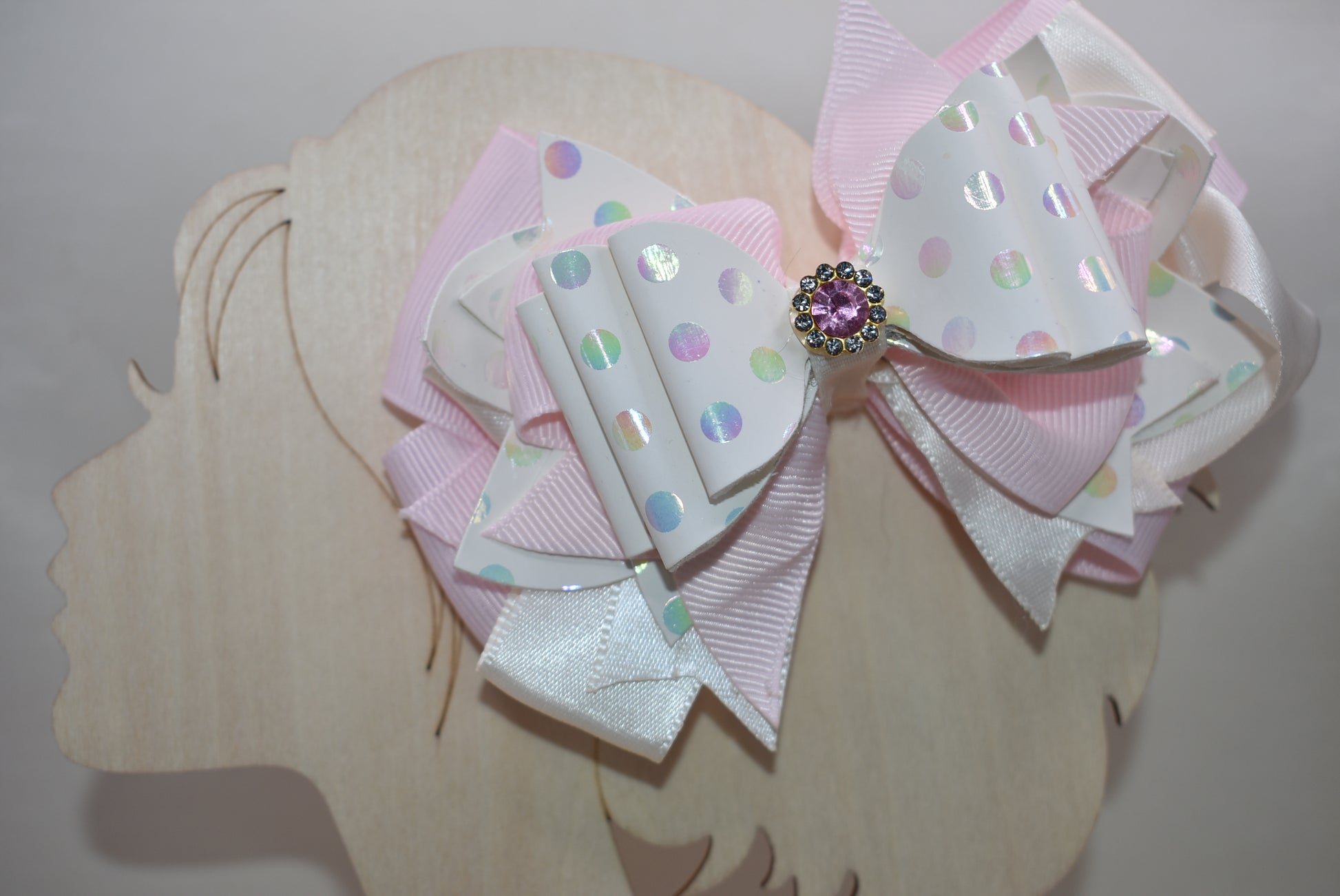 ✨ Introducing the prettiest pink bow that'll make any little girl's heart skip a beat! 💕 This adorable accessory features layers upon layers of luxurious ribbon and faux leather, creating a dimensional look that's absolutely stunning. Whether you're dressing up for a special occasion or adding a touch of charm to everyday wear, this versatile bow does it all. 👑 The sparkling crystal charm perched on top adds that extra dash of magic and elegance. Each piece is truly one-of-a-kind, making it a special trea